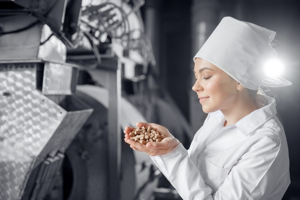 woman worker holds supplement product in hands in a manufacturer.