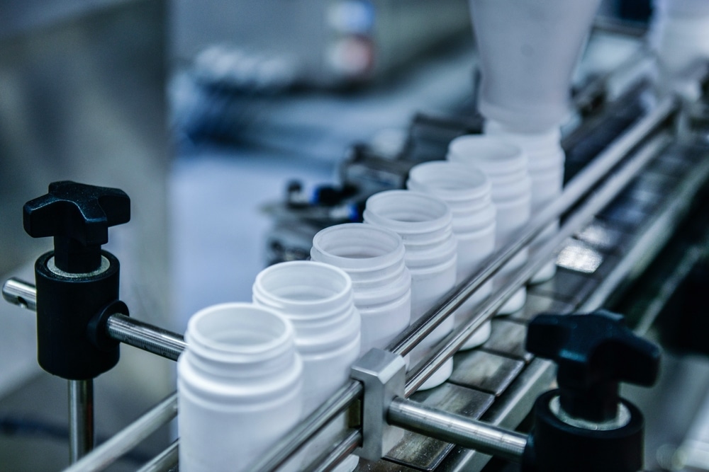 Supplement bottle on the conveyor belt for the filling process